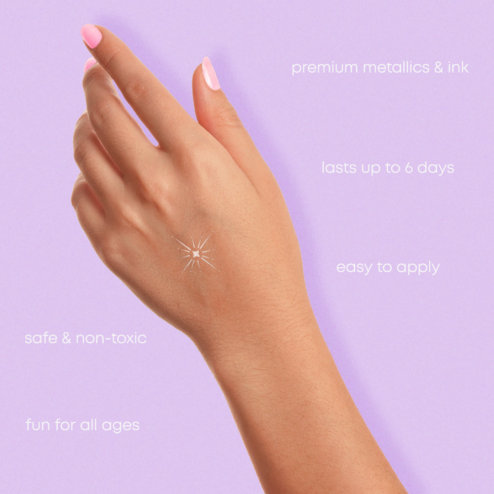 Silver shining star metallic temporary tattoo on a hand