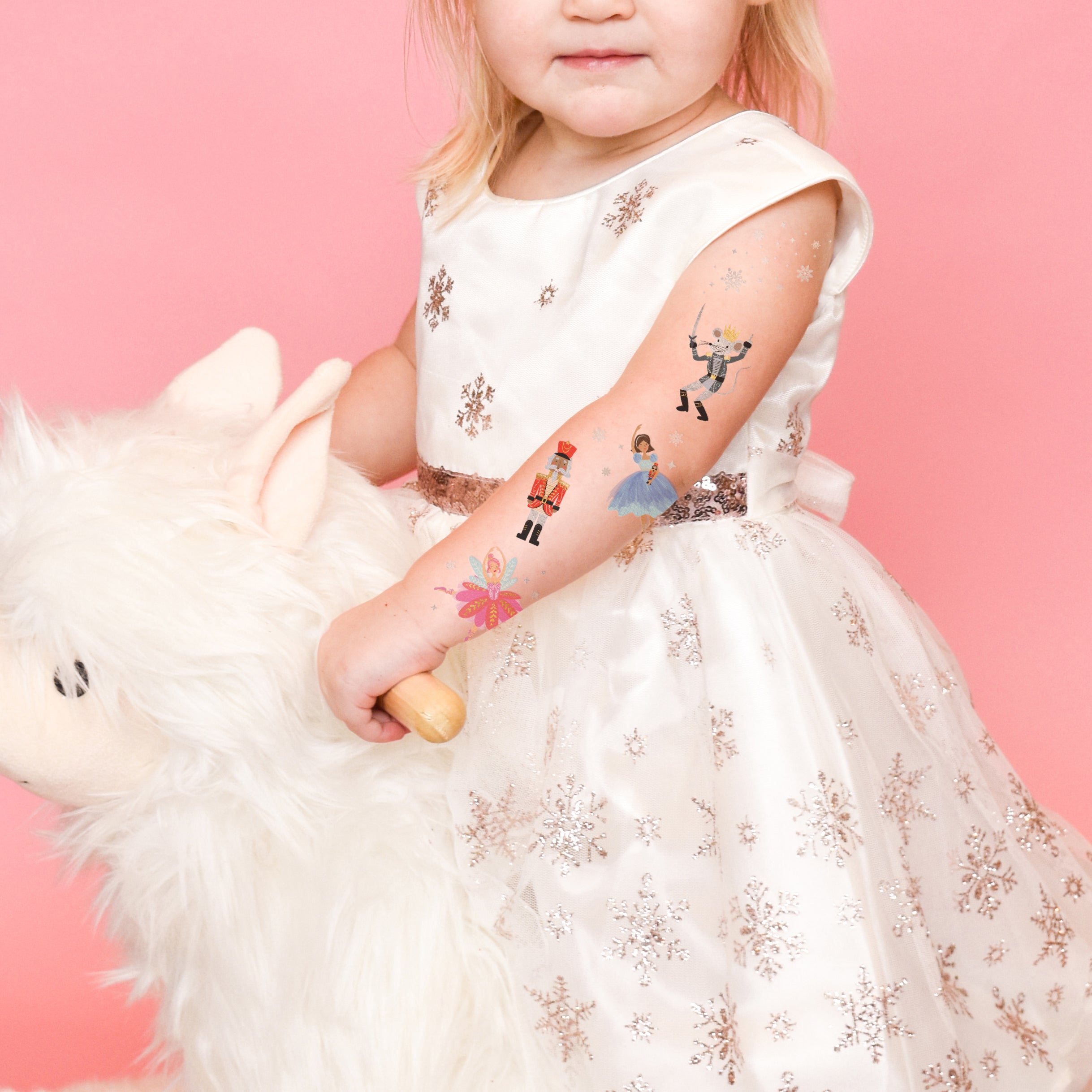 Shine bright in the Nutcracker Variety Set from Flash Tattoos featuring 25 assorted holiday inspired kids temporary tattoos: Clara, Nutcracker, Sugar Plum Fairy, Rat King and Snow shimmer.