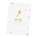 Set of metallic temporary tattoos featuring a witch hat and broom, rainbow over a yellow brick road, red ruby slippers, pink and evil witches, and a princess wand.