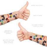 Children's arms with colorful monster truck temporary tattoos that are great for events, party favors, invitation additions, gifting and more! 