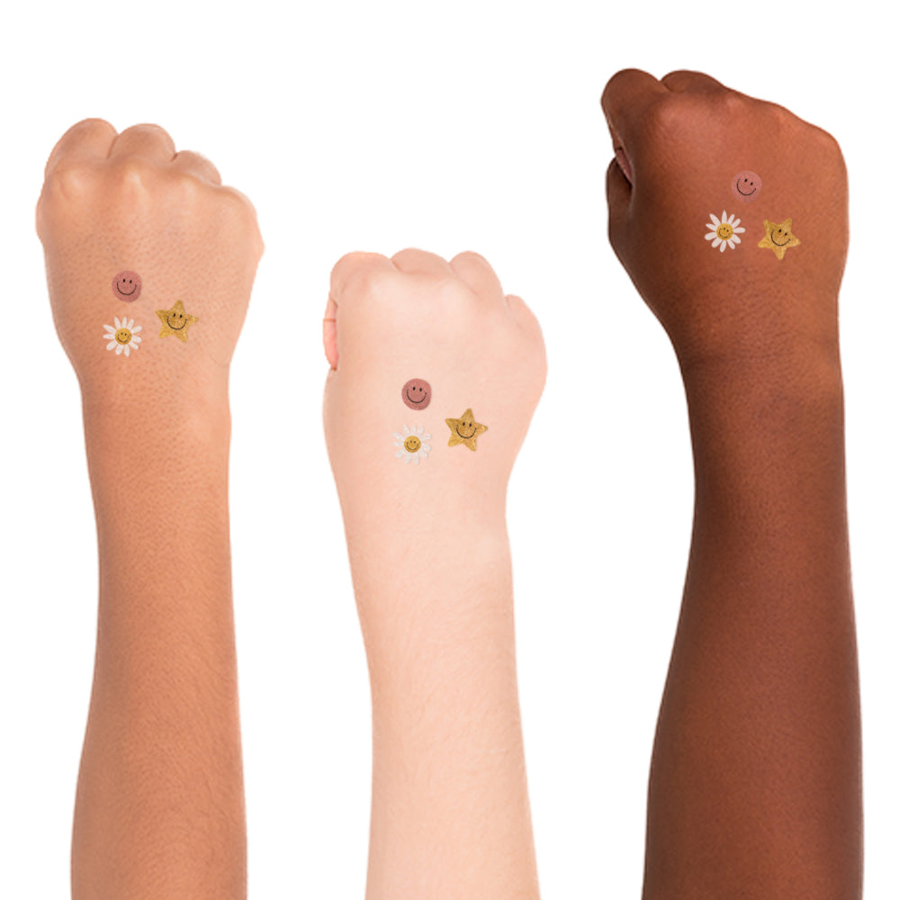 Set of 10 metallic temporary Daisy Charms tattoos for kids. Hippie inspired designs featuring smiley daisy, smiley face pink metallic and star smiley face in metallic gold