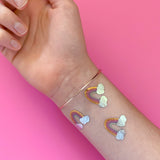 Lovely Rainbow metallic tattoo party tat set featuring 10 pre-cut metallic tattoos. The perfect addition to birthday parties, celebrations and more!