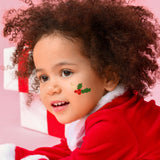 Child wearing a temporary tattoo on cheek of a Green holly with red berries temporary tattoo with metallic gold branch