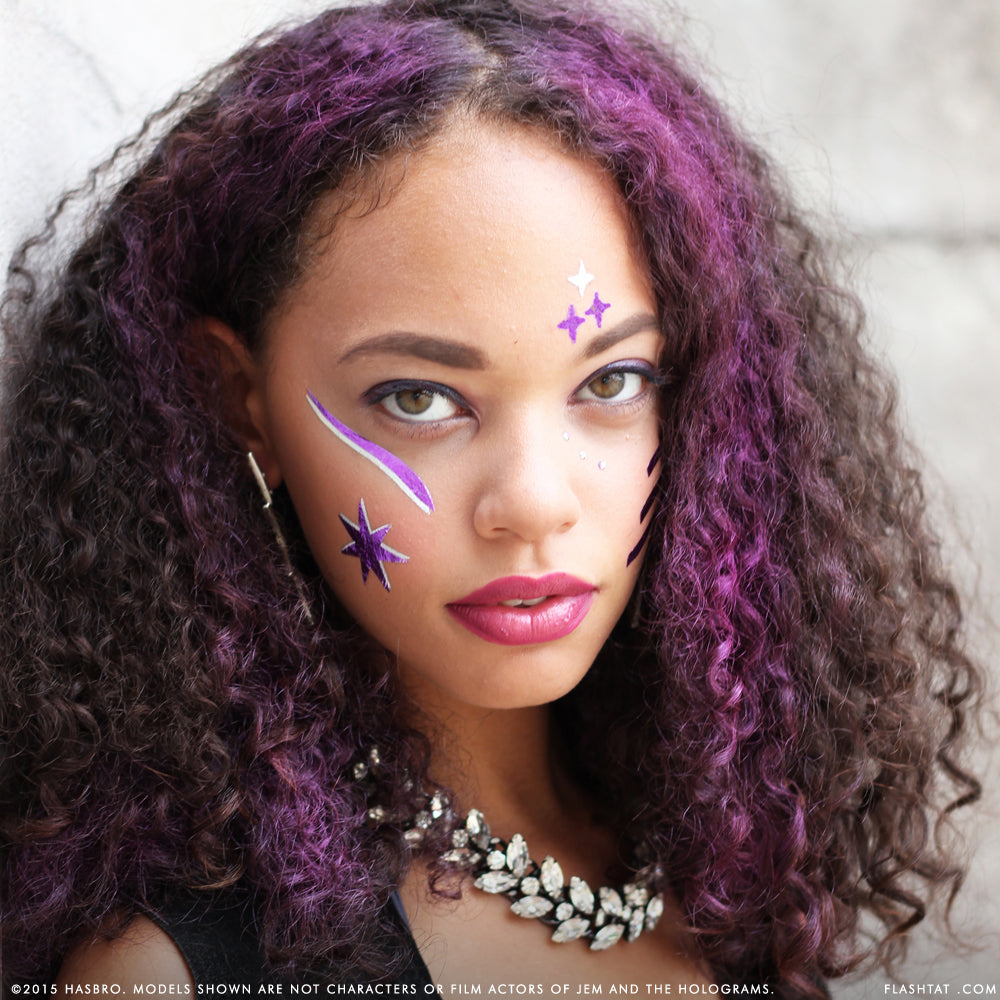 Shine on! Flash Tattoos metallic purple and gold face tattoos adorned with Swarovski crystals