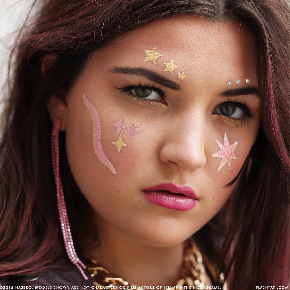 Rock on- metallic gold stars and crystals adorn eyebrows with cheeks featuring Jem pink and gold rockstar designs by Flash Tattoos.