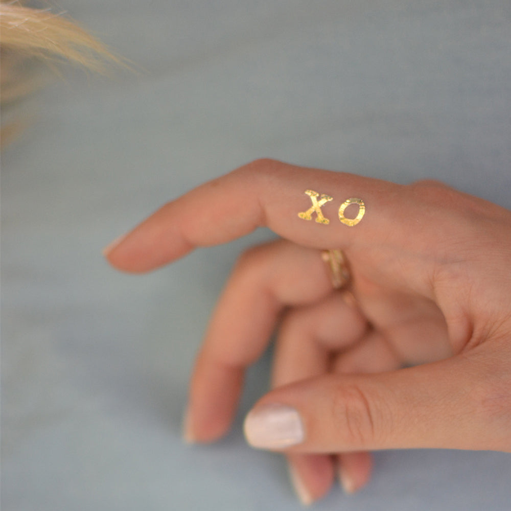 Shine bright in the XO metallic gold temporary tattoo